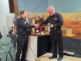 Les Tulloch presenting certificate to Jeff Seidel